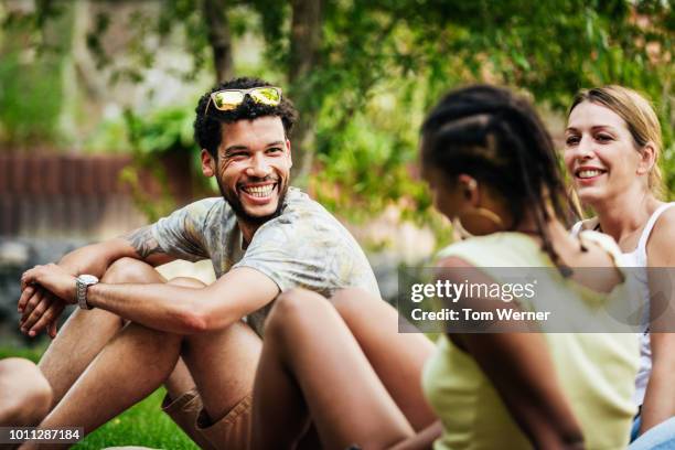 group of friends sitting down together in the sun - black and white food fotografías e imágenes de stock