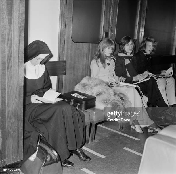 Mick Jagger and Marianne Faithfull share a waiting room with a nun at London Airport , 13th April 1968.
