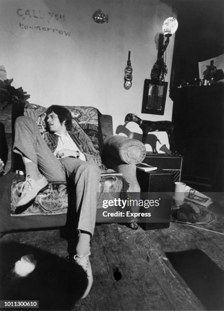 Singer Mick Jagger of The Rolling Stones lounging on a sofa, circa 1967.