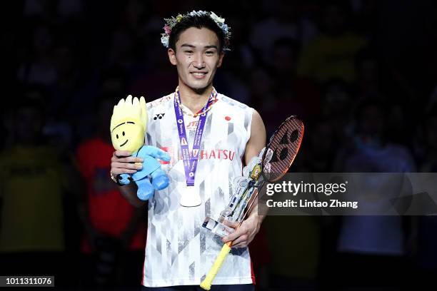 Kento Momota of Japan poses with her medal on the podium after defeating Shi Yuqi of China in the men's singles final on day 7 of Total BWF World...