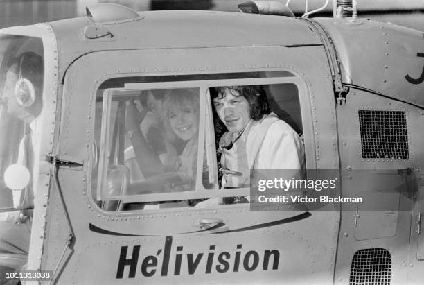 Mick Jagger and Marianne Faithfull aboard a helicopter at Battersea Heliport in London, 1st August 1967. They are flying to Ongar in Essex, where...