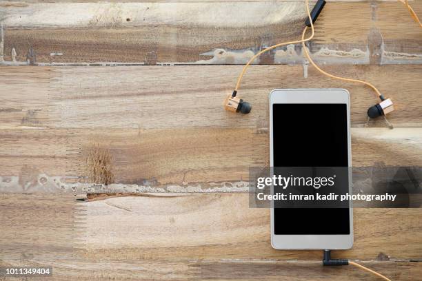 mobile phone on wooden table. - portability stock pictures, royalty-free photos & images