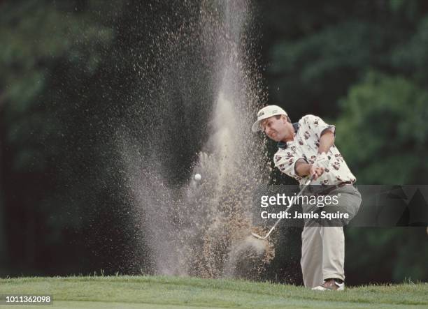 Kevin Sutherland of the United States keeps his eye on the ball as he hits out of the bunker during the PGA Buick Classic tournament on 14 June 1998...
