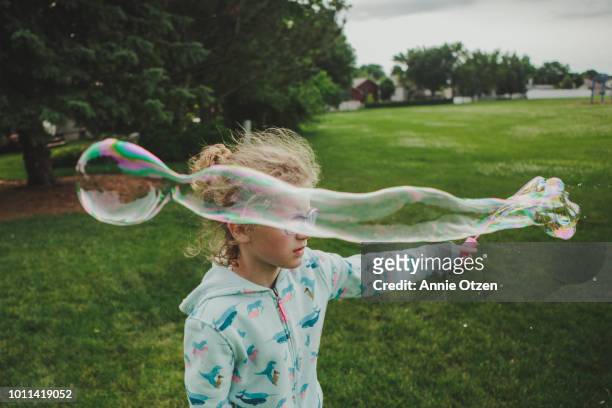 Girl making a long bubble