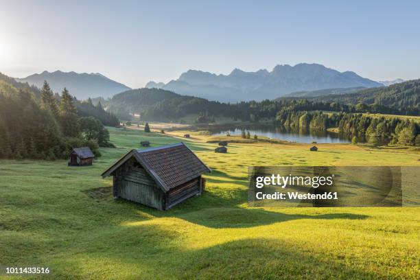 germany, bavaria, werdenfelser land, lake geroldsee with hay barn, in background the karwendel mountains - cabane structure bâtie photos et images de collection