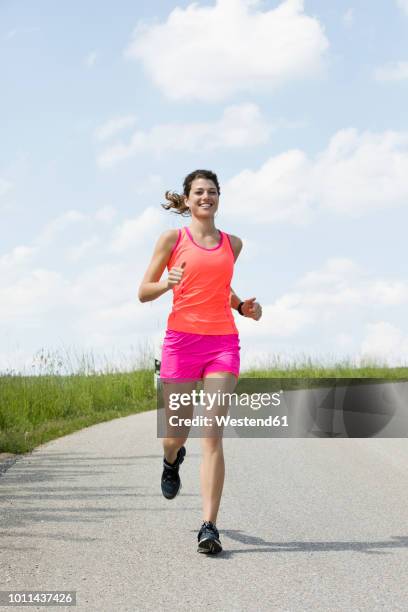 young woman jogging - woman jogging ストックフォトと画像