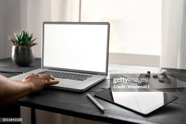 modern office with laptop and digital tablet on desk - ipad hand foto e immagini stock