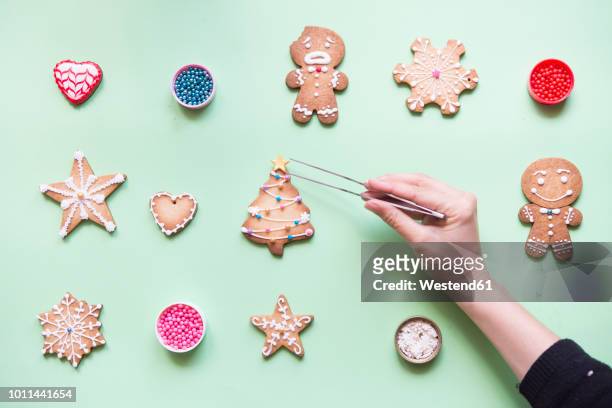 Woman's hand decorating Gingerbread cookies