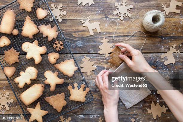 woman's hands packing homemade christmas cookies into sachet - gift lounge stock pictures, royalty-free photos & images