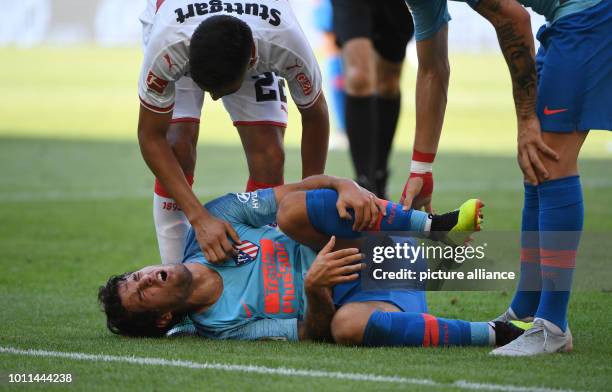 August 2018, Germany, Stuttgart: soccer, test match, VfB Stuttgart vs Atletico Madrid in the Mercedes Benz Arena. Madrid's Roberto Olabe lies on the...