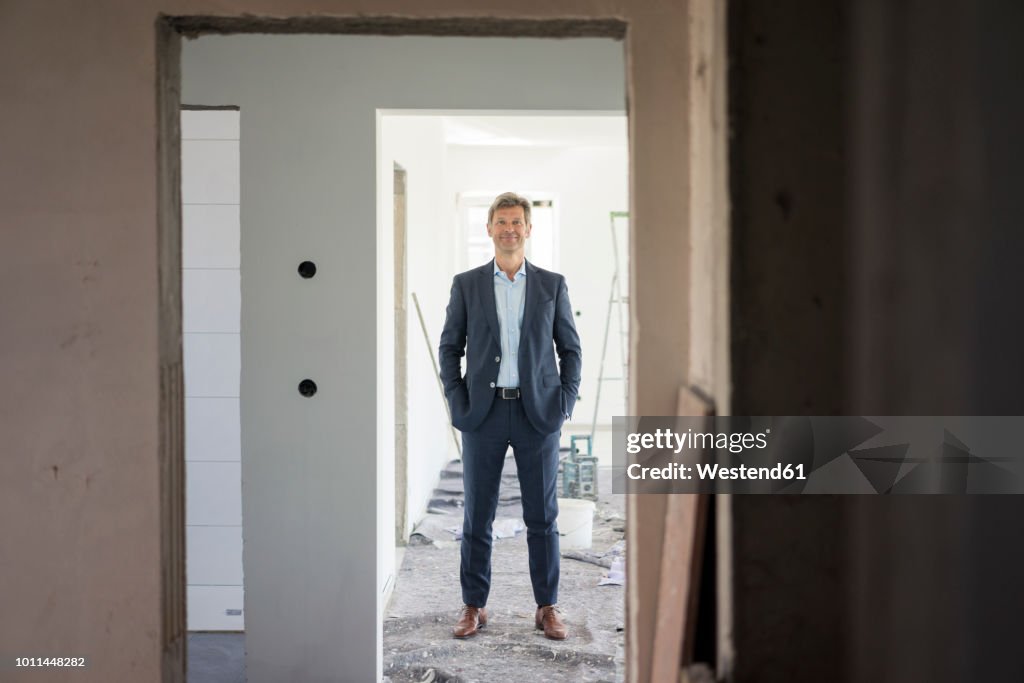 Man With Building Portrait Of Smiling Man In Suit In Building Under Construction High-Res ...