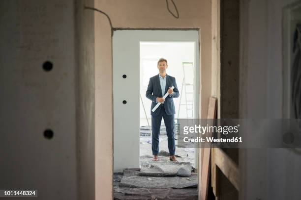 architect standing in building under construction - site visit stock pictures, royalty-free photos & images