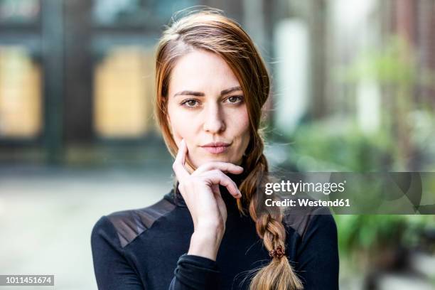 portrait of serious woman with braid - assertiveness stock pictures, royalty-free photos & images