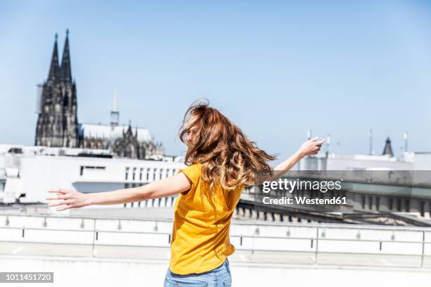 germany, cologne, woman dancing on roof terrrace - north rhine westphalia bildbanksfoton och bilder