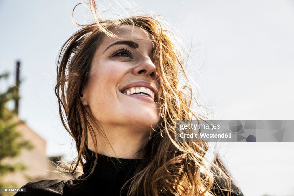 Portrait of happy woman with blowing hair