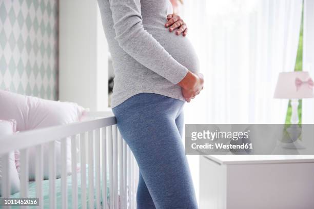 pregnant woman holding baby belly - nursery bedroom stock pictures, royalty-free photos & images