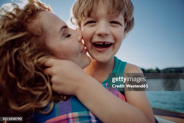 mother and happy son at a lake - tooth bonding stock pictures, royalty-free photos & images