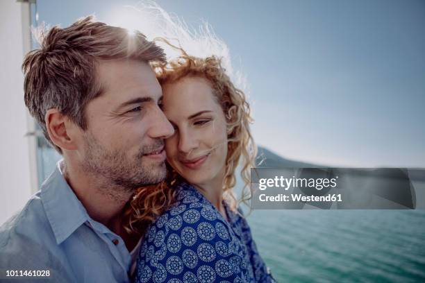happy couple on a sailing boat - paar mittleren alters stock-fotos und bilder