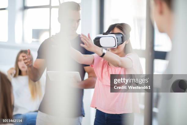 teacher with tablet student wearing vr glasses in class - kids interacting in the classroom stock-fotos und bilder