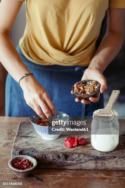 woman preparing muesli - schale stock-fotos und bilder