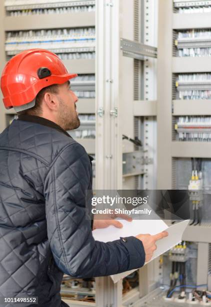 engineer checks the functionality of the equipment in control room - distribution board stock pictures, royalty-free photos & images
