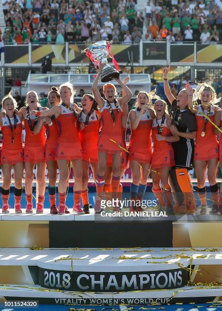 Netherland's captain Carlien Dirkse van den Heuvel and her team celebrate with the trophy after winning the field hockey final match between the...