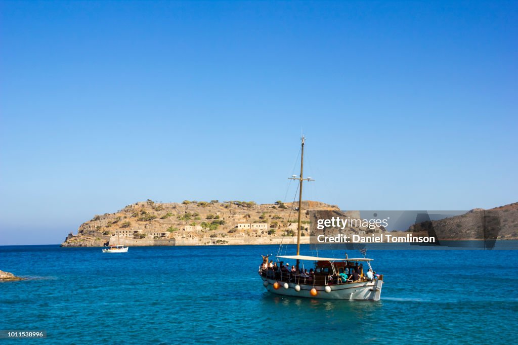 Tourist Boat Near Spinalonga Fortress Near Agios Nikolaos, Crete, Greece.