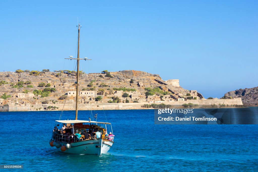Tourist Boat Near Spinalonga Fortress Near Agios Nikolaos, Crete, Greece.