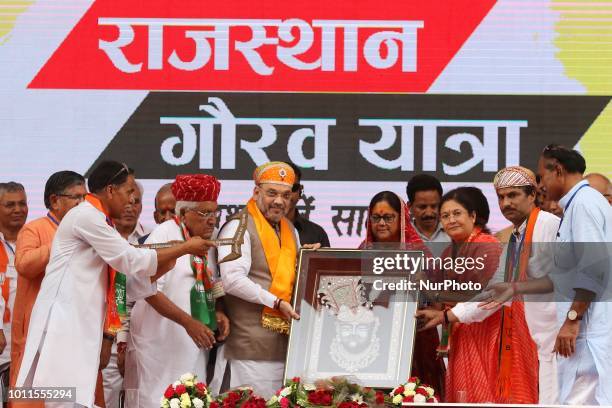 President Amit Shah and Rajasthan Chief Minister Vasundhara Raje being felicitated by party workers during a public meeting to starts 40 days long...