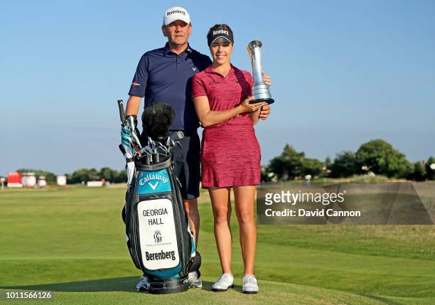 Georgia Hall of England holds the trophy with her father Wayne Hall who is her caddie after the final round of the Ricoh Women's British Open at...
