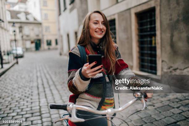 using smart phone while riding a bike - white glove phone stock pictures, royalty-free photos & images