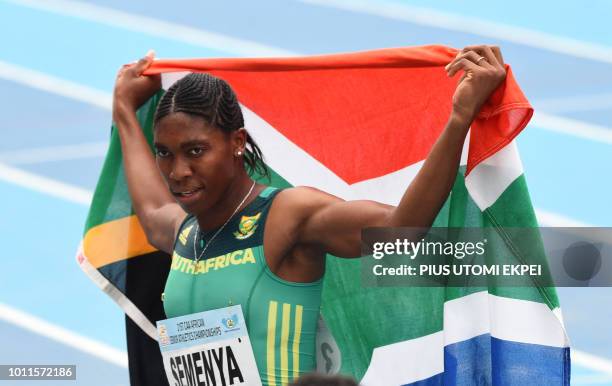 South-Africa's Caster Semenya celebrates with her national flag after winning the women's 800m of the African Athletics Championships at the Stephen...