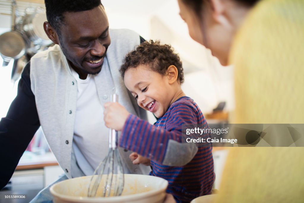 Happy father and son baking in kitchen