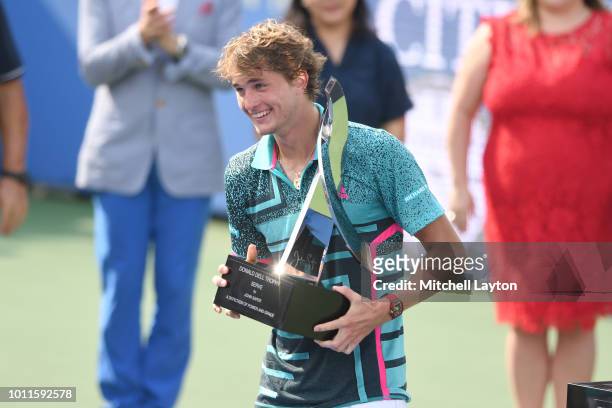 Alexander Zverev of Germany holds the winners trophy after his match against Alex De Minaur of Australia during the Men's Finals on Day Nine of the...