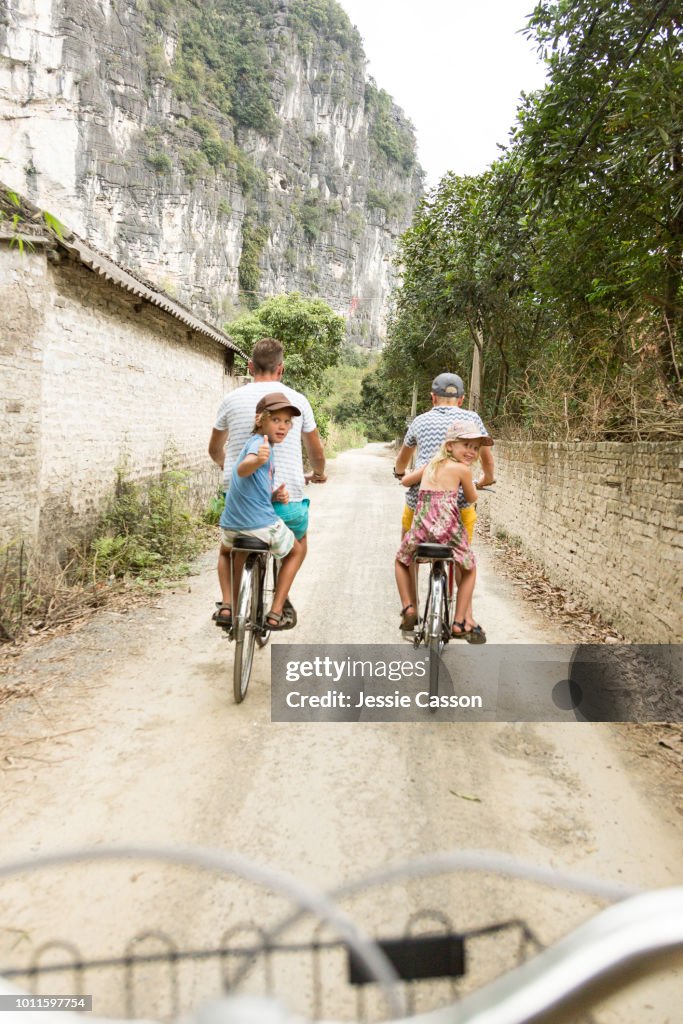 A family cycle through rural landscape in Ninh Binh