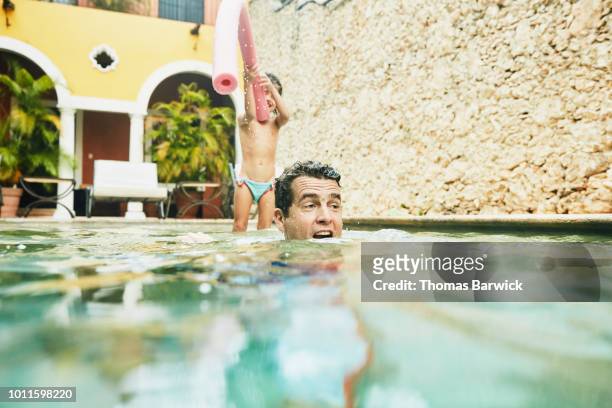 father playing with daughter in pool at tropical resort - hot mexican girls stock pictures, royalty-free photos & images
