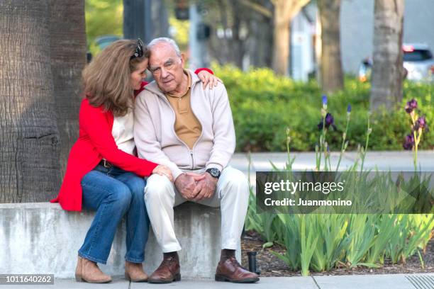 senior man possing with his daughter - alzheimer's stock pictures, royalty-free photos & images