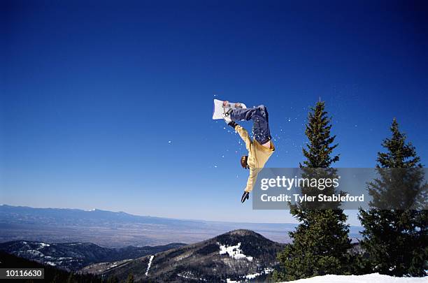 male snowboarder jumping in santa fe, new mexico - snowboard jump bildbanksfoton och bilder