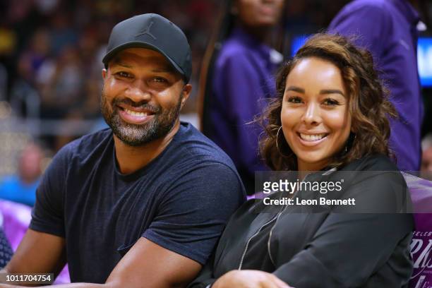 Retired NBA player Derek Fisher and Gloria Govan take in the Phoenix Mercury vs Los Angeles Sparks during a WNBA basketball game at Staples Center on...