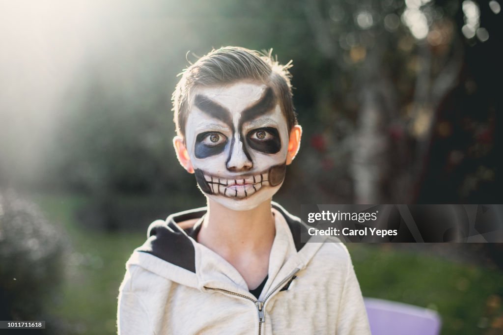 Portrait of a little boy with skeleton make up for halloween