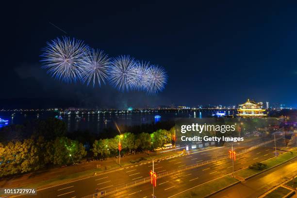 Fireworks light up the sky over the Juzizhou scenic spot during a music firework celebration on the China's Army Day on August 1, 2018 in Changsha,...