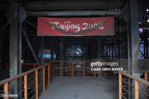 This photo taken on July 23, 2018 shows a faded Beijing 2008 sign in the grandstand of the beach volleyball stadium built for the 2008 Beijing...