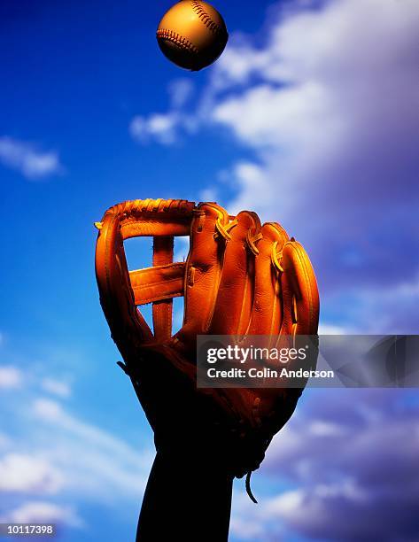 baseball being caught in mid flight - baseball glove stock pictures, royalty-free photos & images