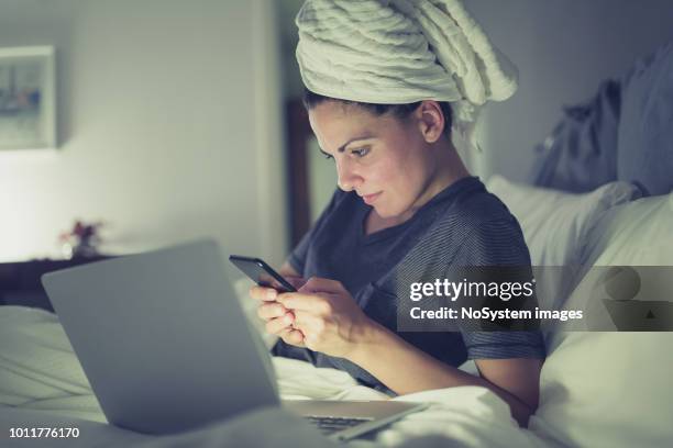 young women working late at home using laptop - wet hair stock pictures, royalty-free photos & images