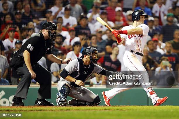 Andrew Benintendi of the Boston Red Sox hits the game-winning walk-off single to defeat the New York Yankees in the tenth inning at Fenway Park on...