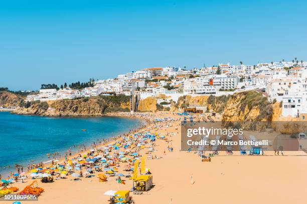 people on the beach in summer, algarve, portugal - albufeira beach stockfoto's en -beelden