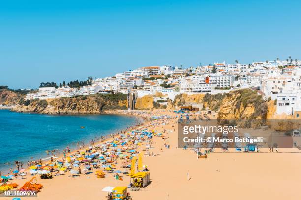people on the beach in summer, algarve, portugal - albufeira stock pictures, royalty-free photos & images