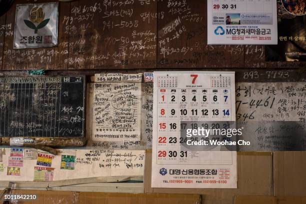 Year-old Baek Seokhoon looks back the projected map of his home town, Bakcheon-gun in Pyeonganbukdo, North Korea in his store in Seoul, South Korea...