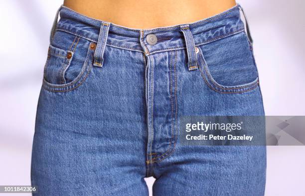 close up of front of woman wearing denim jeans - jeans foto e immagini stock