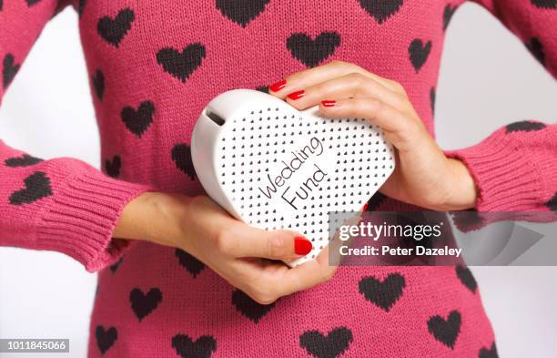 woman holding her wedding fund savings - moment collection stockfoto's en -beelden